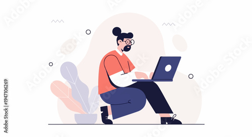 Person with beard and bun hair using a laptop, seated