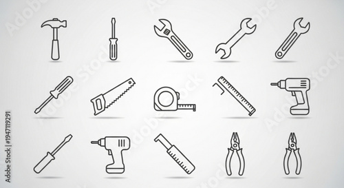 Collection of various hand tools and power tools for construction and repair work on a plain background