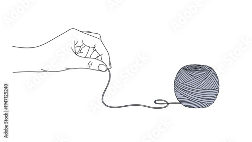 Human hand gently pulling a loose end of thread from a small ball of grey yarn used for knitting or sewing projects.