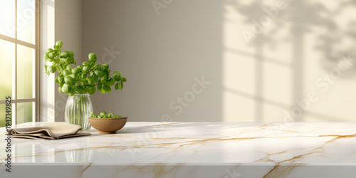 Modern kitchen marble countertop with fresh green basil plant in glass vase and bowl of green olives near window with sunlight and soft shadows creating calm atmosphere