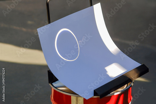 Outdoor projection of the ring of fire and its reflections on a white cardboard during a day with an annular solar eclipse.