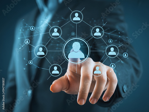 A person in a business suit is interacting with a virtual network of people, symbolizing connectivity and collaboration.