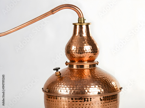 Traditional hammered copper still with condenser arm for distilling beverages