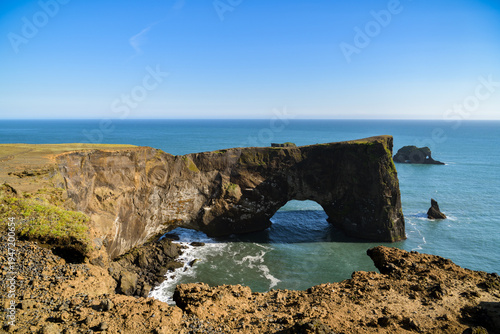 Natural sea arch at Dyrholaey cliffs in Iceland