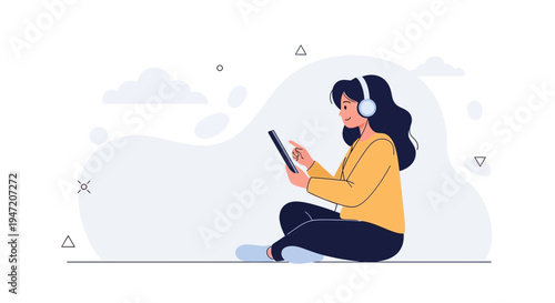 Woman with headphones using tablet, sitting cross-legged, enjoying music or online content