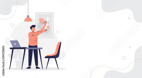 Man Decorating Office Wall with Abstract Art, Laptop on Desk