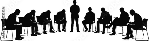 Silhouette illustration of group training session with leader standing in center, participants seated in semi‑circle reading or writing, concept of education, teamwork, leadership, guidance