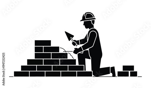 A silhouette of a professional bricklayer wearing a safety helmet working on a masonry wall task