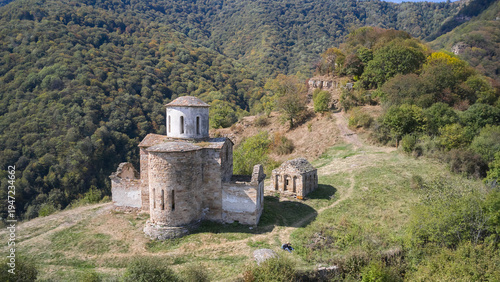 The ruins of an ancient Christian temple in the Visaitian style high in the mountains. Sentinsky Temple, Karachay-Cherkessia. Drone footage.