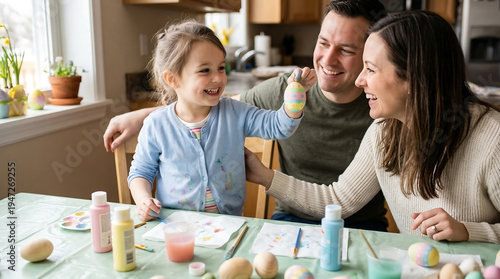  Happy family painting easter eggs at Home