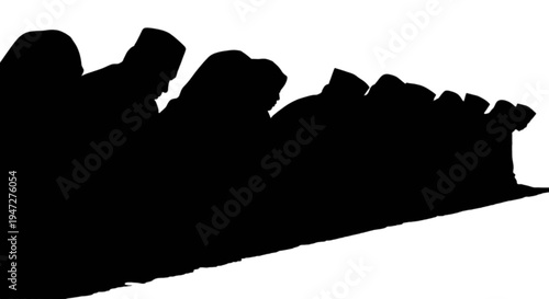 Silhouettes of people sitting closely together in a row