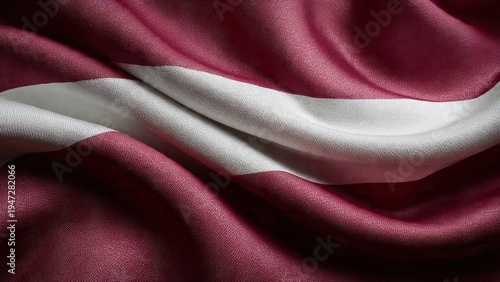 The Latvian flag waving gently in the wind with its distinctive red and white colors