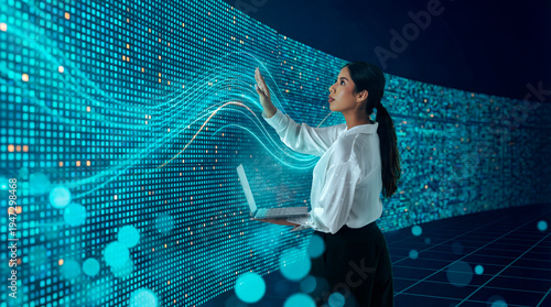 Latin woman interacting with digital data wall using laptop