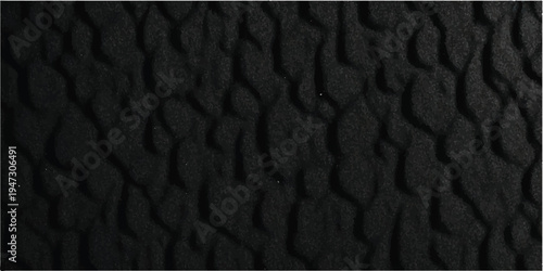 A macro closeup of dark black leather texture reveals a rough, natural material surface with an old skin pattern, perfect for a fashion design backdrop or textured wallpaper