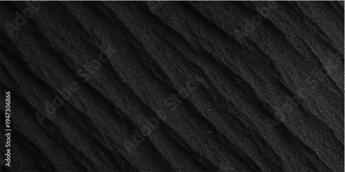 A dark, textured black fabric and leather material surface featuring a rough macro pattern design for a fashion textile backdrop or wallpaper
