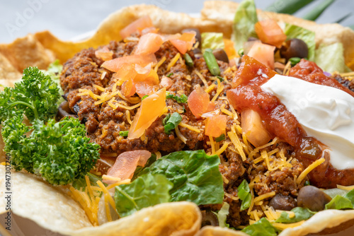 taco salad with ground beef cheese salsa and sour cream