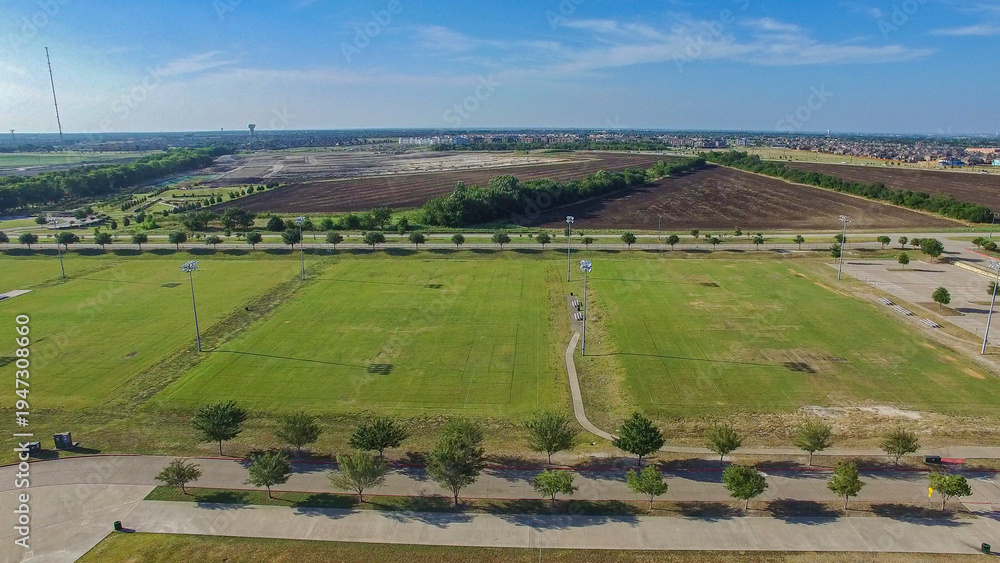 Fototapeta premium Aerial Drone photo of McKinney Soccer Complex at Craig Ranch at sunset
