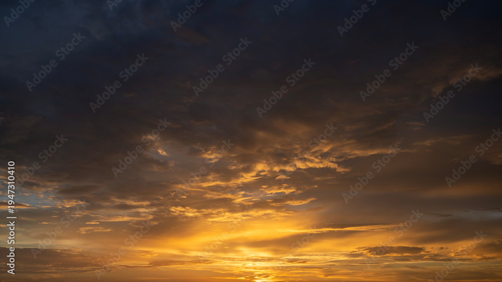 Fototapeta premium Amazing sunset skyscape. Evening sky with bright colorful orange and yellow clouds