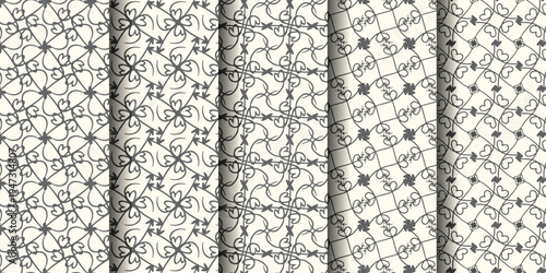 Elegant black and white patterned designs on textured paper rolls exhibiting intricate motifs.