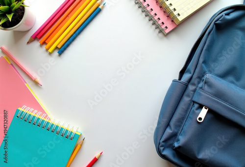 Back to school flatlay: backpack, notebooks, pencils on desk