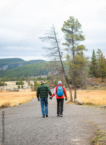 Couple hiking on trail in Yellowstone National Park Wyoming, USA