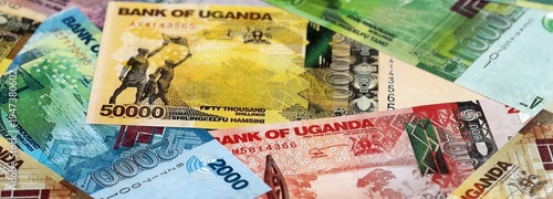 Fotografie Ugandan shilling paper banknotes pile on table