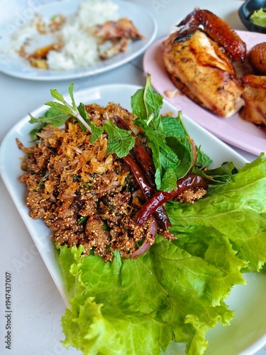 Larb Moo, Thai spicy minced pork salad with fresh herbs and vegetables.