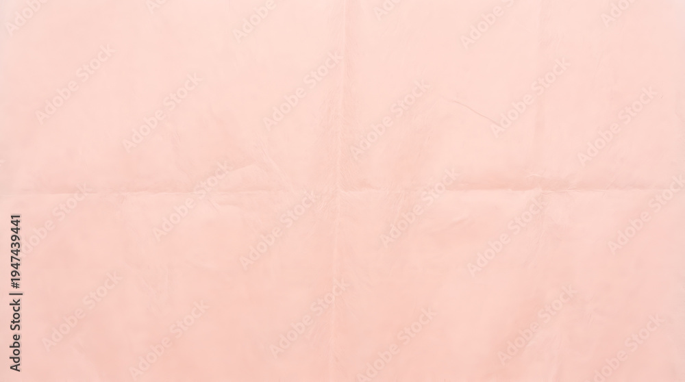 Fototapeta premium A flat lay, close-up perspective of a sheet of light pink paper with subtle wrinkles and creases, forming an interesting soft textured background with a delicate color palette.