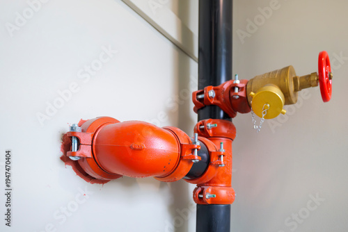Obraz na plátně Fire sprinkler riser pipe with hose valve and orange couplings