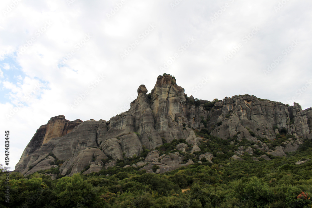 Obraz premium Meteora Rock Formation Landscape August 2024 Ancient conglomerate cliffs with lush forest