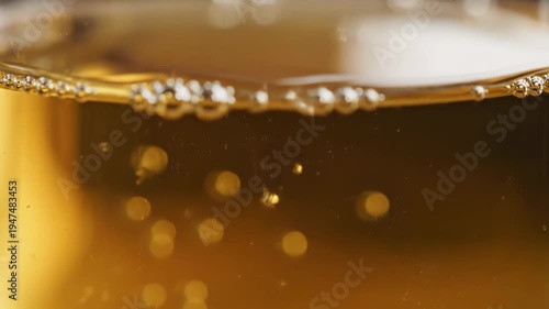 Carbonated beverage with rising bubbles closeup.