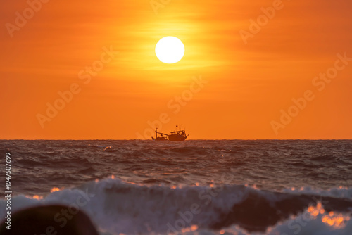 Wallpaper Mural Sunrise landscape at tropical beach. The warm golden light of illuminating the sea spray creates a striking silhouette of the rocks against the glowing sky Torontodigital.ca