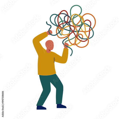 Man struggles to hold colorful tangled wires in chaotic mess indoors