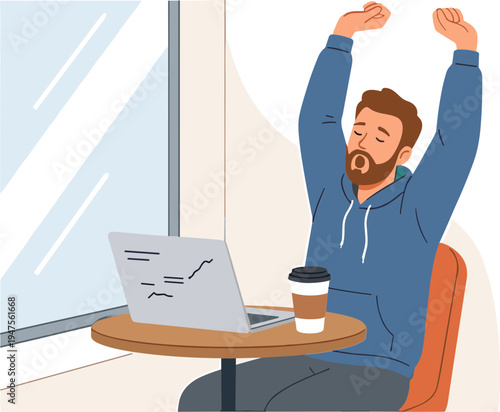 Man stretches arms up while sitting at desk with laptop and coffee cup