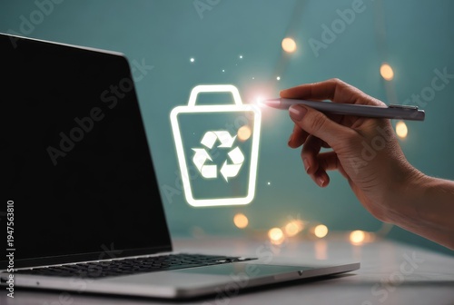 Hand using stylus on laptop screen activating delete or recycle bin icon with bokeh lights