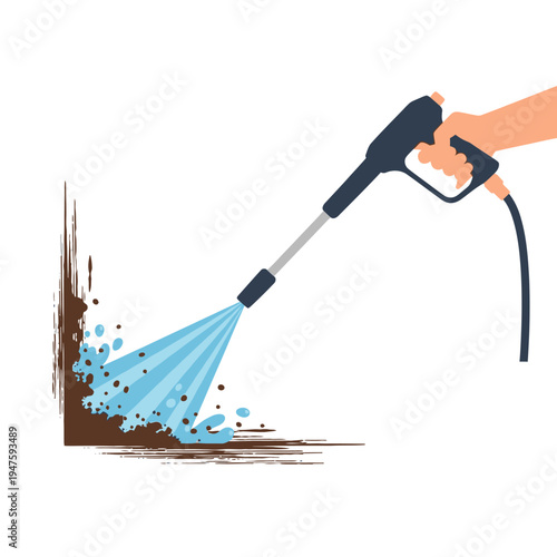 A hand holds a pressure washer cleaning a dirty brown surface