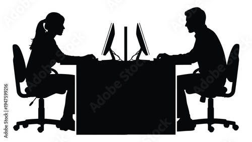 A man and woman sitting at a desk with computers