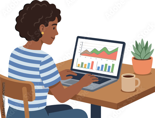 A woman sits at a desk working on her laptop with a plant and coffee nearby