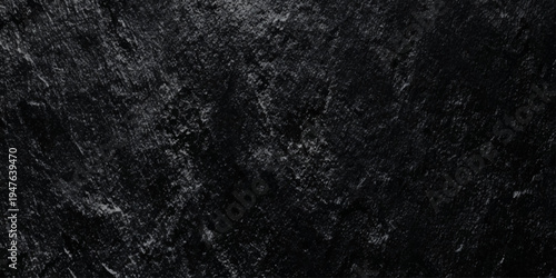Abstract black wall texture background with rough slate surface deep shadows, highlights on jagged edges.