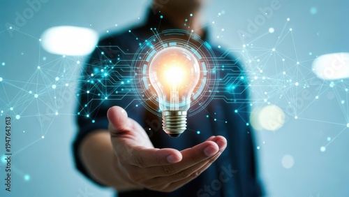 A person holding a glowing light bulb symbolizing innovation and ideas