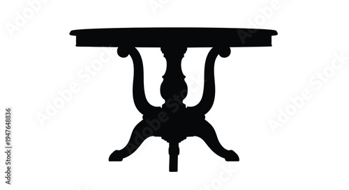 Silhouette of an ornate dark table with a circular tabletop