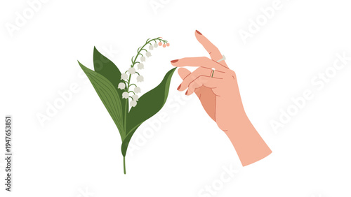 Delicate female hand with rings reaching out to touch a fragile lily of the valley flower with white bell shaped blooms.