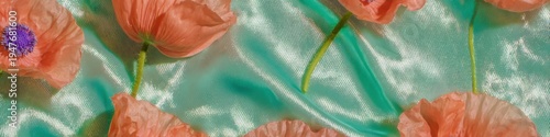 Peach poppy flowers arranged on teal satin fabric as a remembrance day floral background with copy space for commemorative marketing banners and greeting cards