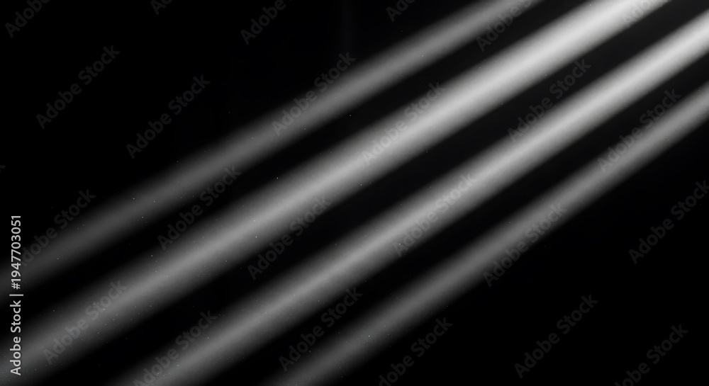 Fototapeta premium Diagonal beams of white light shine through darkness with floating dust particles