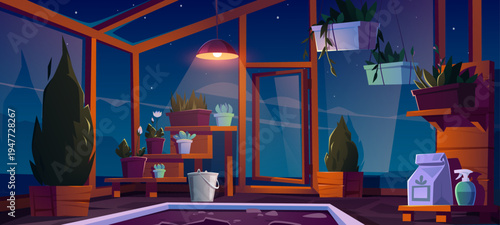 Glass greenhouse interior at night