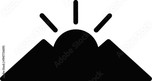 Silhouette of a rising sun over mountains