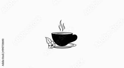 Steaming hot coffee in a black cup with a delicate flower accent