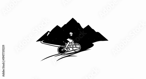 Silhouette of a cyclist riding a bike with mountains in the background