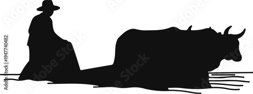 Silhouette of a farmer plowing with a bull