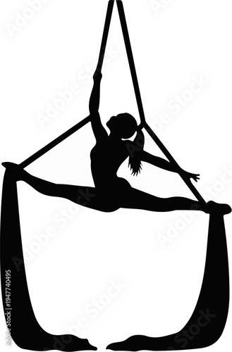Silhouette of a flexible performer doing a split while suspended by aerial silks